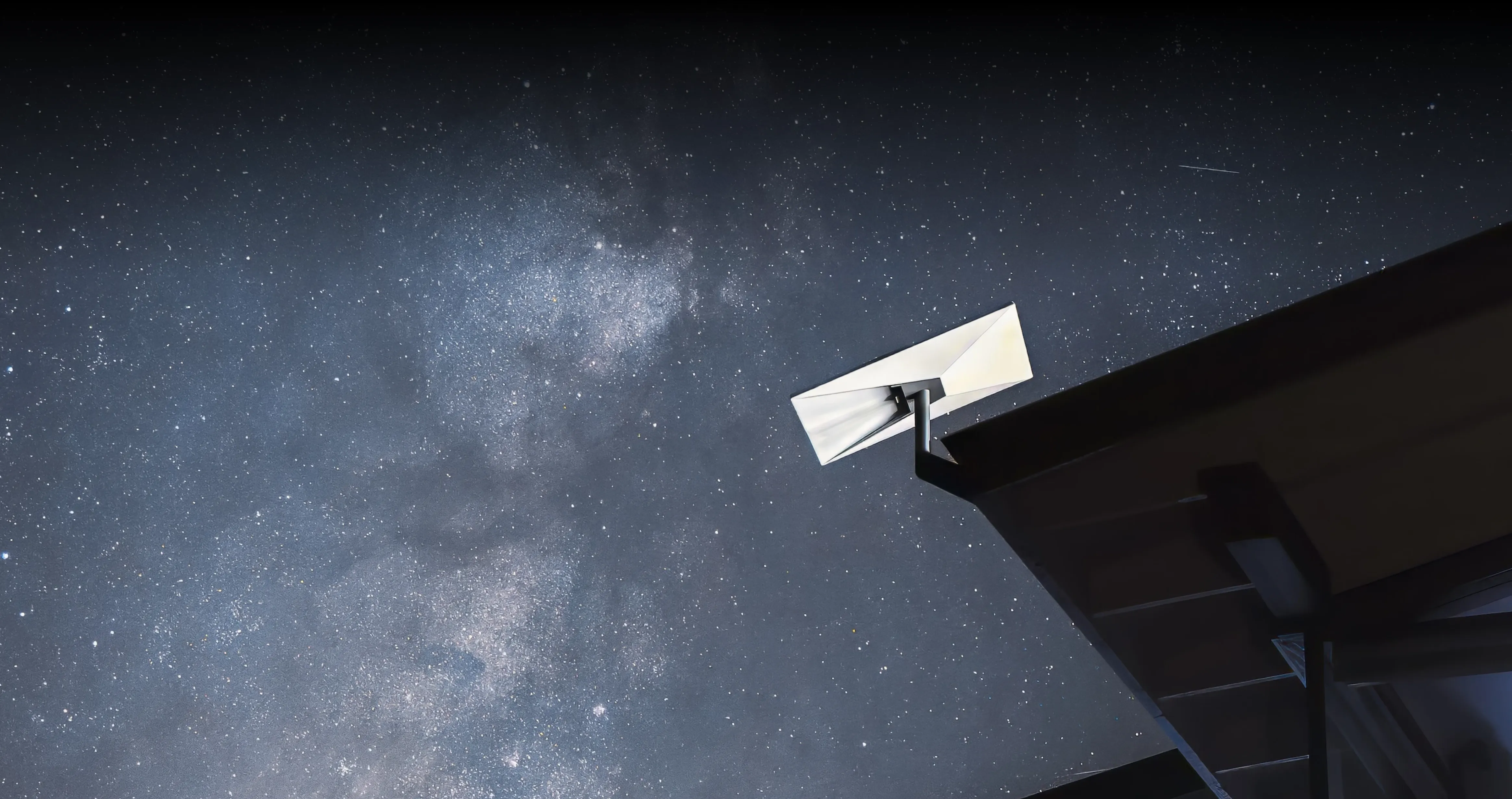 Starlink satellite dish under a starry sky